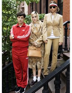 two women and a man standing on the steps