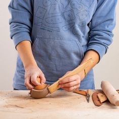 a person is using a wood shaving tool