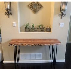 a wooden table with hairpin legs in front of a mirror