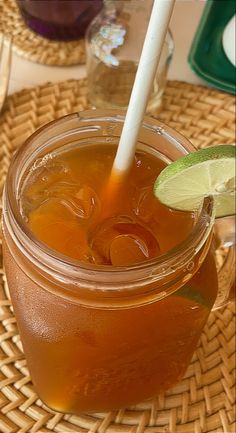 a drink in a mason jar with a lime wedge