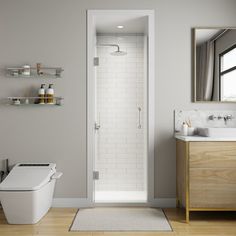 a white toilet sitting next to a wooden cabinet in a bathroom under a large mirror