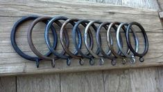 a bunch of horseshoes hanging on a wooden wall