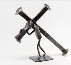 a metal figurine holding two crossed swords