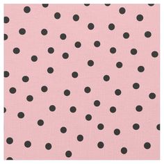 a pink background with black polka dots