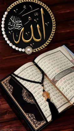 an open book sitting on top of a wooden table next to a tassell