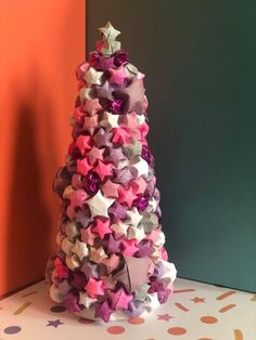 a christmas tree made out of pink, purple and silver stars