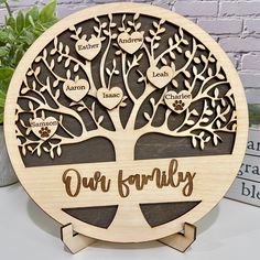 a wooden family tree with names on it