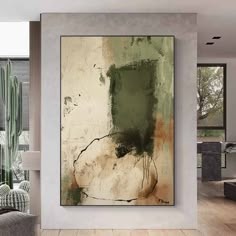 an abstract painting hangs on the wall in a modern living room