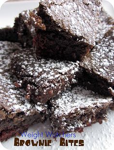 brownie bites covered in powdered sugar on top of a white plate with text overlay