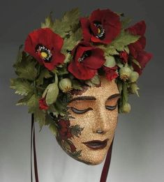 a woman's head with flowers and leaves on it, wearing a flower crown