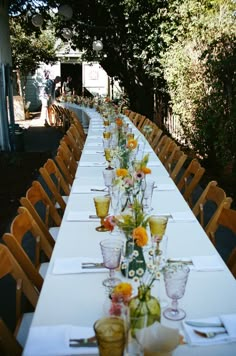 the long table is set with many glasses and plates