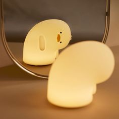 a light that looks like a ghost in front of a mirror