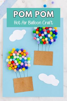 two hot air balloons made out of paper on top of a blue background with the words pom pom