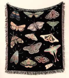 a black blanket with many different moths on it