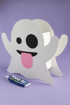 a white ghost with its tongue out next to a candy bar