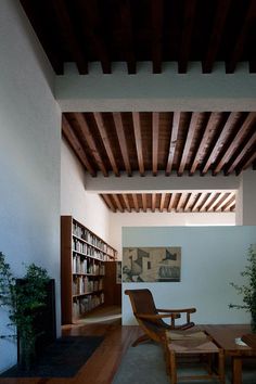 a living room filled with furniture and a book shelf