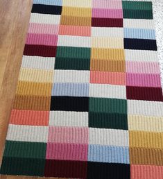 a multicolored rug is laying on the floor