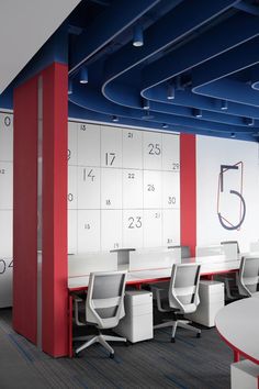 an office with red, white and blue decor on the walls is pictured in this image