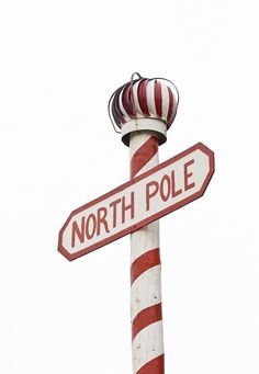 a pole with a street sign that says north pole