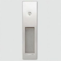 a white door handle on a wall with a light switch in the middle and an image of a button