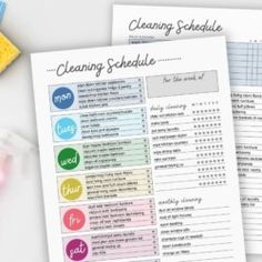 two cleaning schedules sitting on top of a table