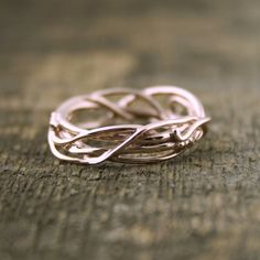 a close up of a ring on a wooden surface with the word love written in it