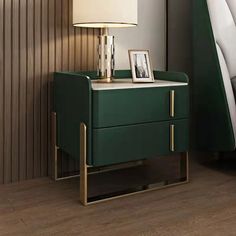 a night stand with a lamp on it next to a green chair and side table