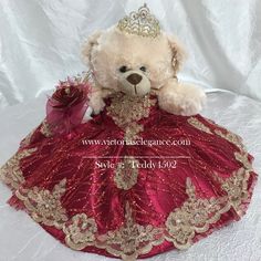 a teddy bear in a red dress with a tiara on it's head