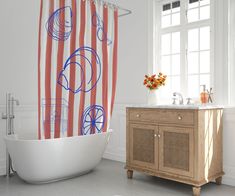 a bath room with a sink and a bath tub next to a large shower curtain