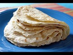 a stack of tortillas sitting on top of a blue plate