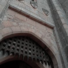 a clock on the side of a stone building