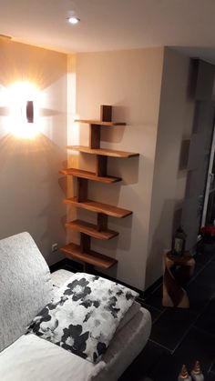 a living room with a white couch and wooden shelves