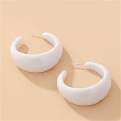 These c-shaped hoop earrings feature a chunky retro shape. Bright white resin makes them pop. 1.45" W x 1.41" L Silver-plated copper / resin Huggie Earrings, Huggies Earrings, Bright White, Travel Pillow, Silver Plate, Silver Plated, Silver Tone, Hoop Earrings, Copper