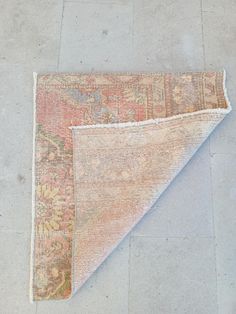 an old rug is laying on the ground