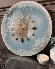 a glass clock sitting on top of a table