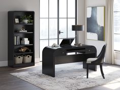 a black desk with a laptop on it