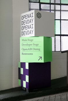 three boxes stacked on top of each other in front of a window with the words openat dev day written on them