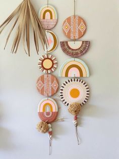 a wall hanging made out of plates and other decorative items, with palm leaves in the foreground