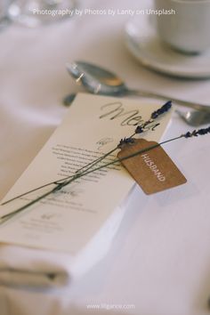 the table is set with place cards and silverware