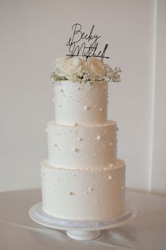 a wedding cake with white flowers on top