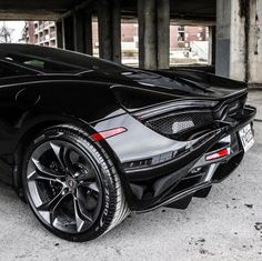 a black sports car parked in a parking garage