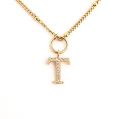 Initial Necklaces are a timeless jewelry box staple and a beloved piece by many. They represent our most important relationships and loved ones and are now available on our Children's Necklace. Our zircon textured initials shimmer and dance from an adjustable 14K gold-plated children's length chain. It's the perfect way to celebrate the wonderful little women in your life. For a limited time only, our Children's Initial Necklaces are wrapped to Christmas perfection in our perfect for under-the-t T Initial, T Necklace, Initial Necklaces, Kids Necklace, Little Women, Timeless Jewelry, Gift List, Red Ribbon, Initial Necklace