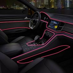 the interior of a car with pink neon lights and steering wheel controls in front of a cityscape