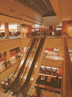 an overhead view of a shopping mall with escalators