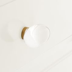 a close up of a knob on a white cabinet