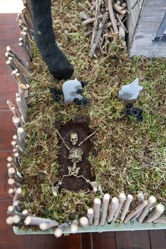 a fake skeleton is in the middle of some grass with bones and bones on it