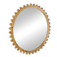 a round wooden mirror with beaded trimmings on the edges and bottom edge