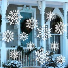 snowflakes are shown on the window of a house