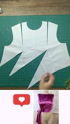 an image of someone cutting out the back of a dress with scissors and sewing tape