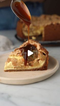 a piece of pie with caramel sauce being drizzled over it on a plate